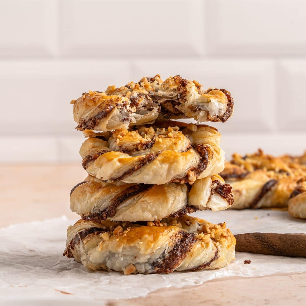 A stack of puff pastries on parchment paper.