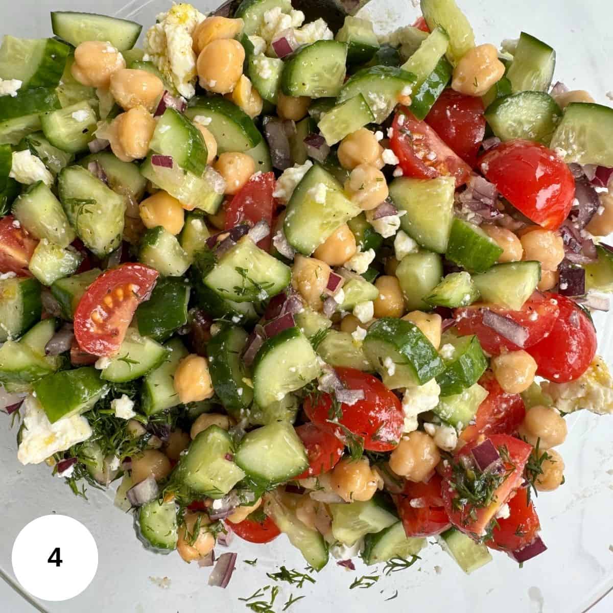Mixing the dressing into the vegetables.