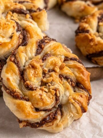 Nutella In Puff Pastry on a wooden board with parchment paper.