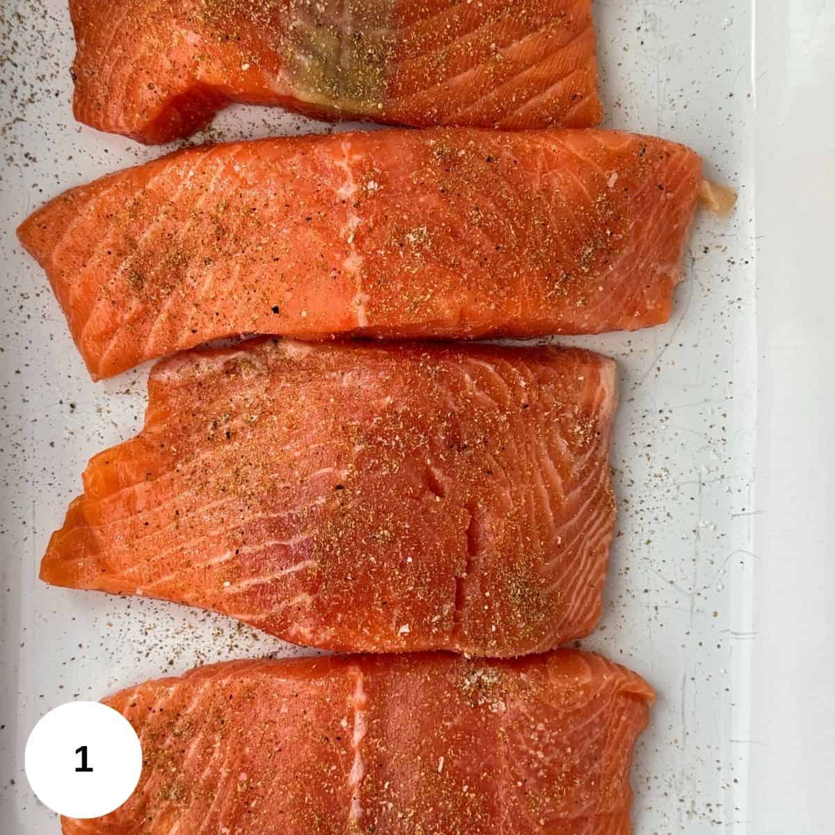 Sprinkling the coriander mixture over the salmon.