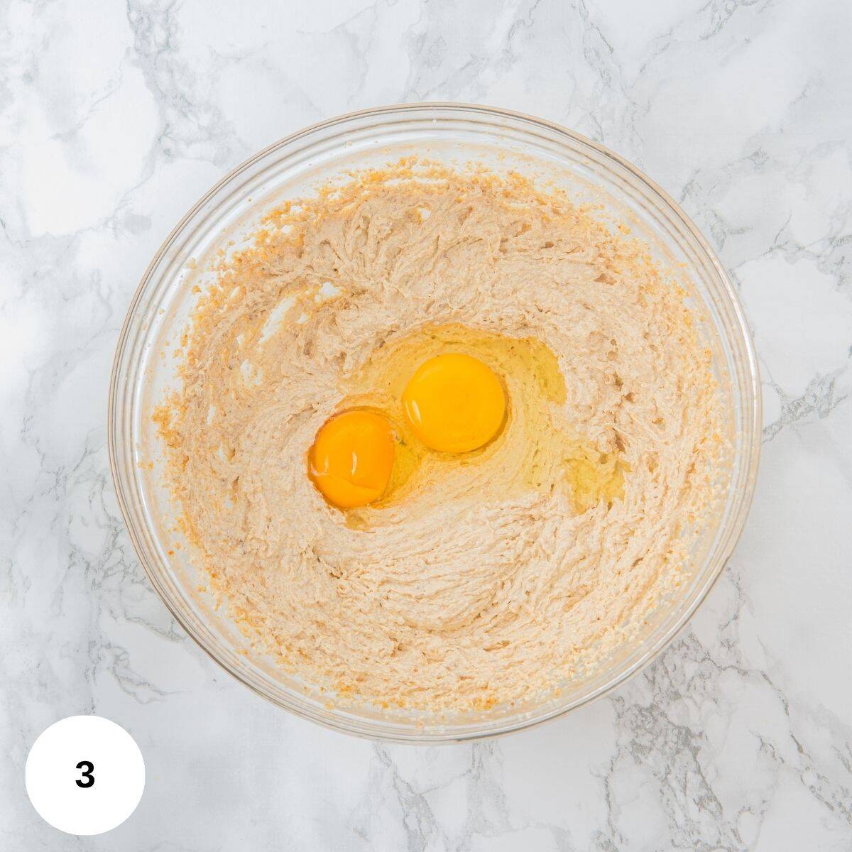 Mixing the eggs with the butter for the dough batter.