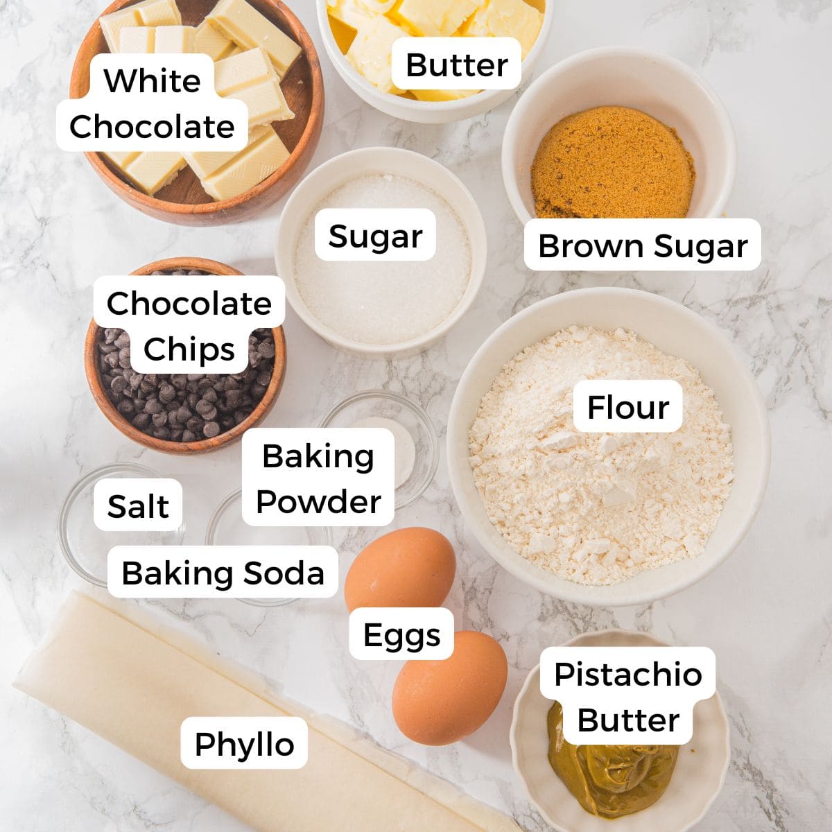 Ingredients include white chocolate, butter, brown sugar, sugar, chocolate chips, flour, baking powder, salt, baking soda, eggs, pistachio butter, and phyllo.