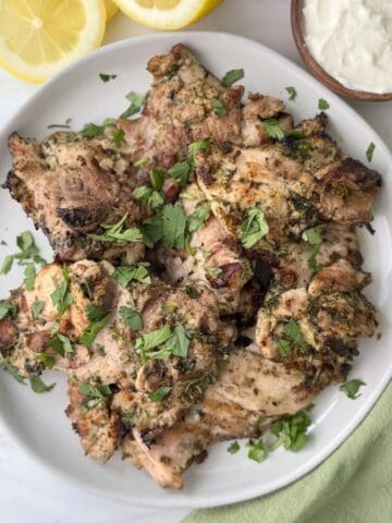 Grilled za'atar chicken with a lemon yogurt garlic sauce on the side.