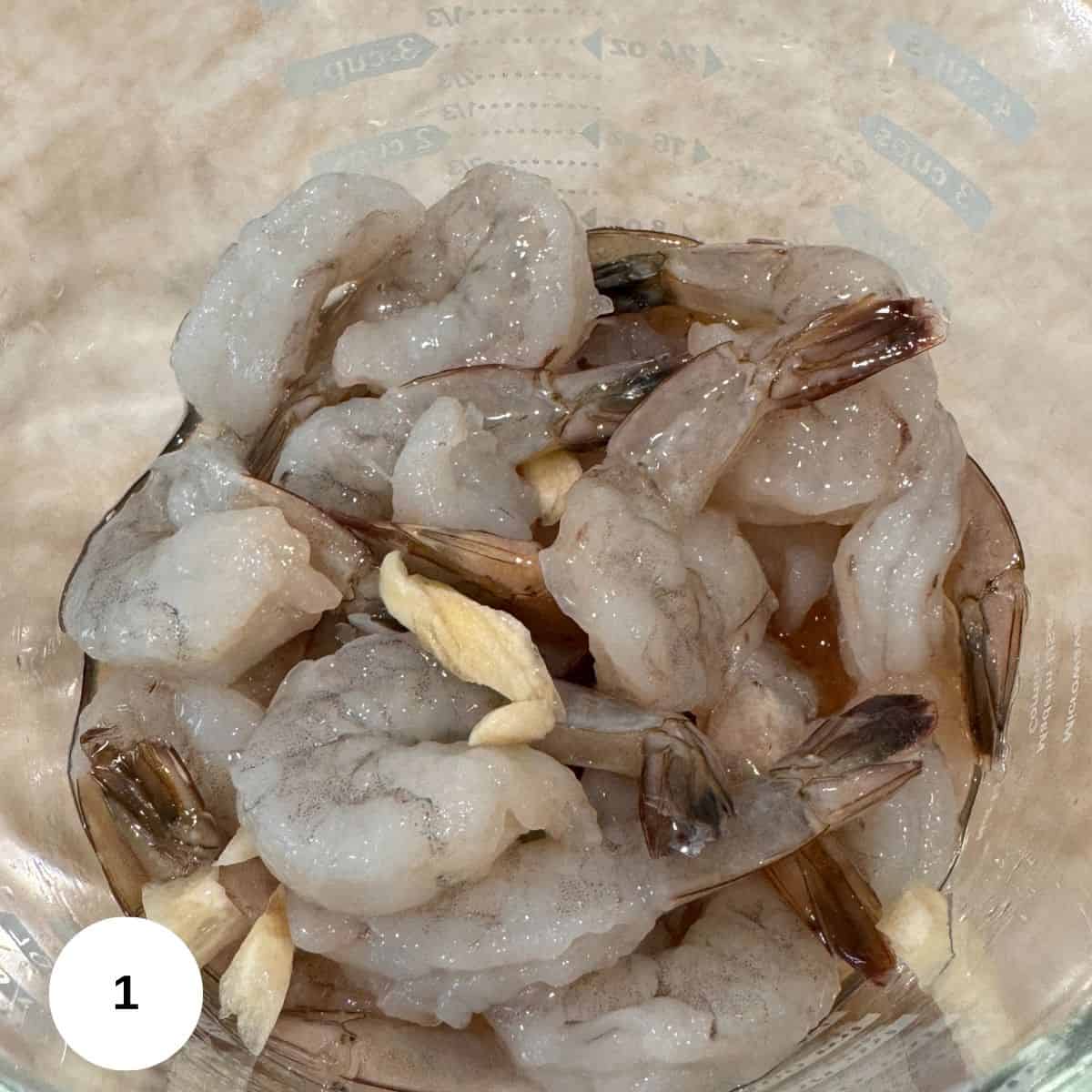 Marinating the shrimp in the sherry wine and garlic. 