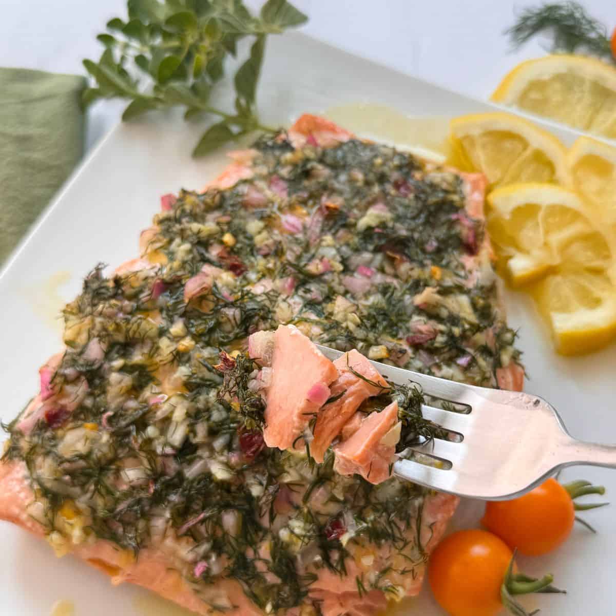 Holding a fork full of the Mediterranean salmon. 