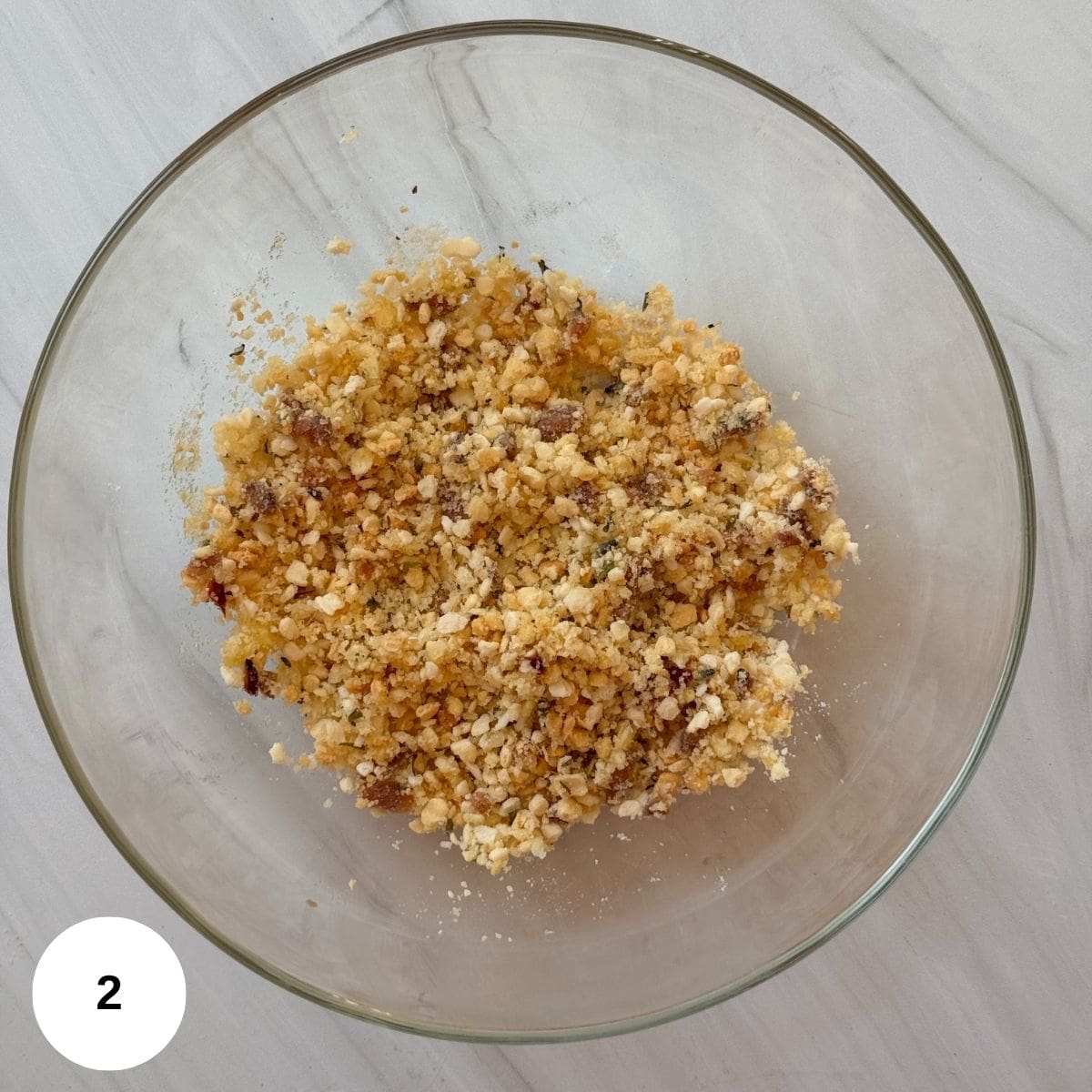 The panko mixture combined in a glass bowl.