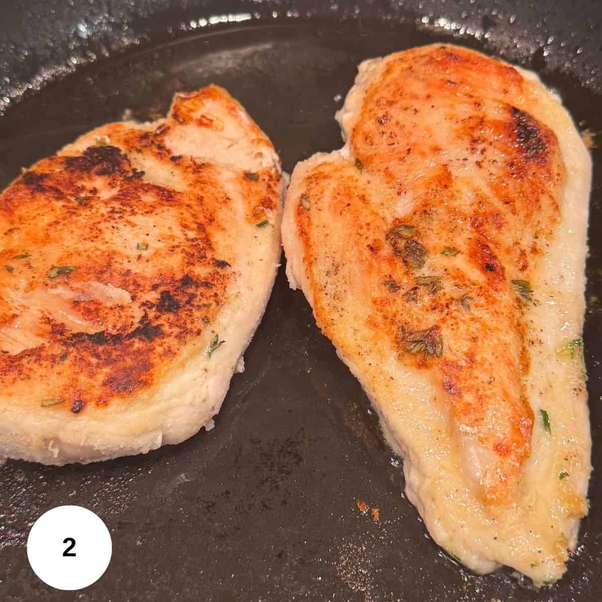 Cooked chicken in a skillet. 