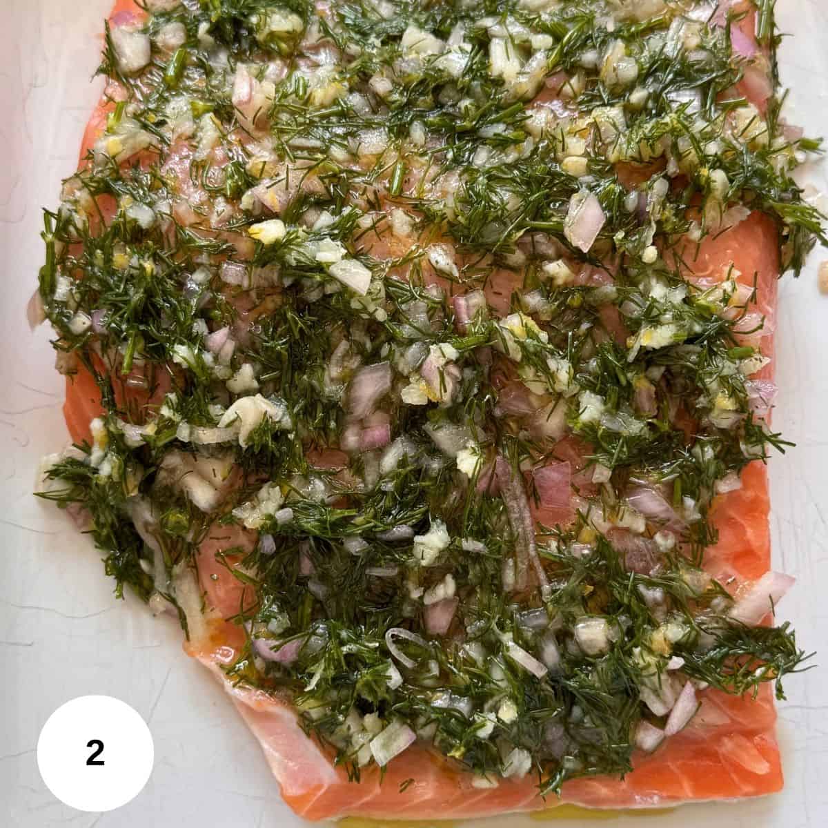 Topping the fish with the sauce. 