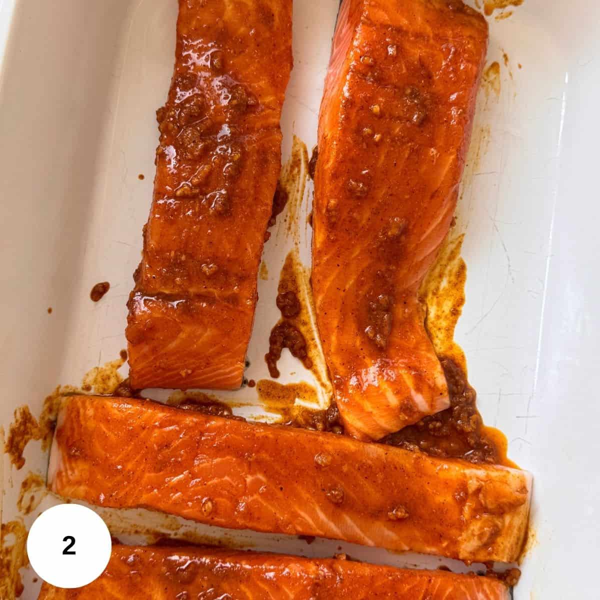 Rubbing the salmon with the spice mixture. 