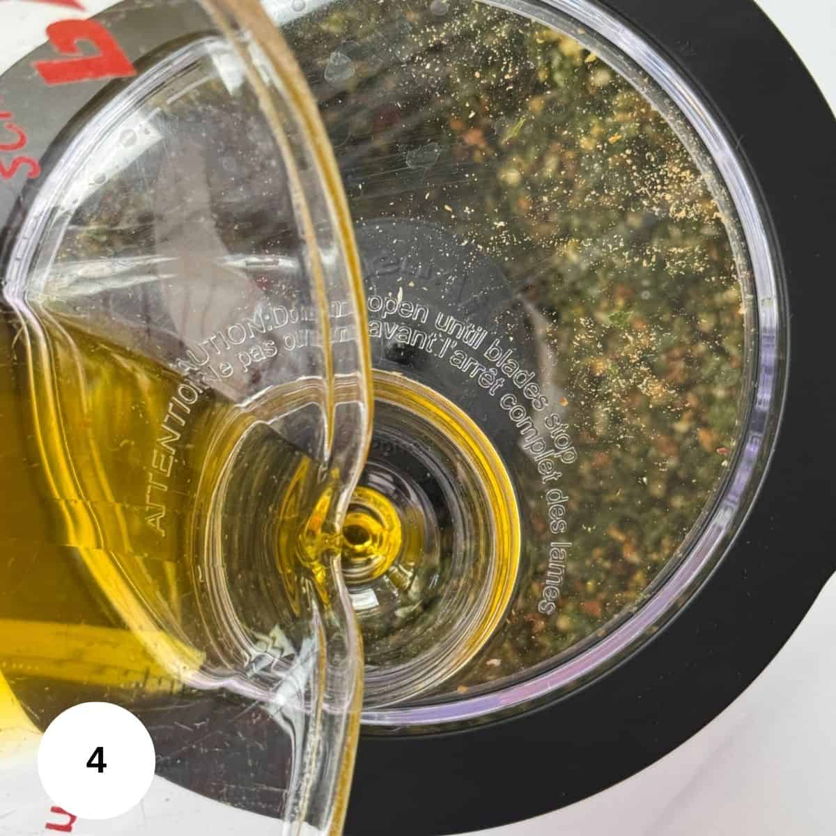 Slowly adding in the olive oil to make the pesto. 