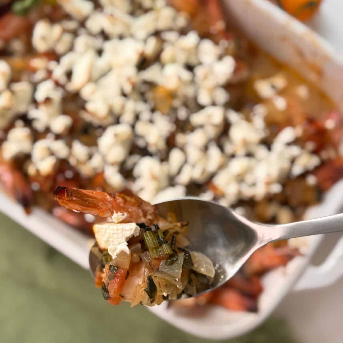 Holding a spoonful of the shrimp dish. 