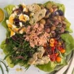 Tuna nicoise salad on a white platter.