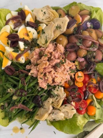 Tuna nicoise salad on a white platter.