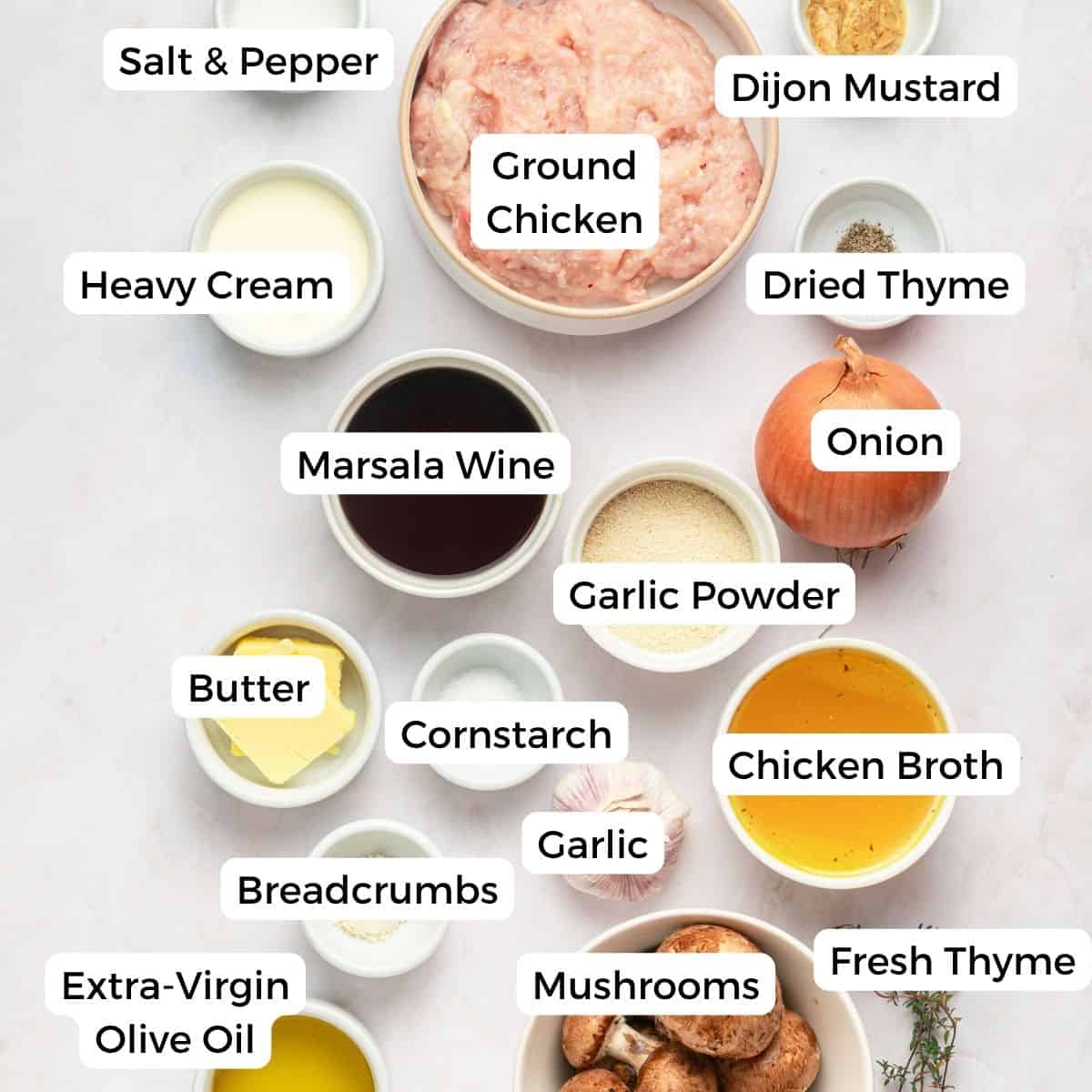 Overhead view of labeled ingredients in bowls for gluten-free Chicken Marsala Meatballs, including ground chicken, marsala wine, mushrooms, garlic, breadcrumbs, onion, broth, herbs, butter, cream, and seasonings—perfect for a one pan meal.