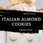 A stack of powdered sugar-coated Italian almond cookies with almond flour, one with a bite taken out, sits above a baking sheet with more cookies. Text overlay reads: Quick & Easy Italian Almond Cookies, Gluten-Free.