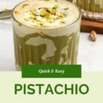 A glass of pistachio latte topped with crushed pistachios sits on a white surface, with a second glass and a spoon with pistachio spread in the background. Text reads “Quick & Easy Pistachio Latte Recipe.”.
