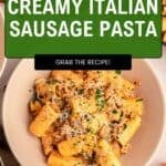 Top-down view of a bowl of creamy pasta with Italian sausage, rich sauce, and grated cheese, garnished with herbs. Text overlay says Quick & Easy Creamy Italian Sausage Pasta - Grab the recipe!.