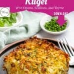A slice of crispy potato kugel garnished with herbs sits on a gray plate with cutlery. In the background, small bowls of sliced green onions and fresh herbs add flavor. Text above invites you to download the delicious potato kugel recipe.