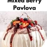 A gluten-free berry pavlova topped with whipped cream, fresh strawberries, raspberries, blueberries, and a vibrant berry sauce, displayed on a white plate. Text reads Gluten-Free Mixed Berry Pavlova.