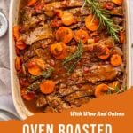 A white baking dish with sliced oven roasted brisket, topped with carrots, herbs, and sauce. The text reads: With Wine And Onions – savor this tender oven roasted brisket.