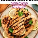 A plate of grilled greek chicken with yogurt marinade, garnished with lemon slices and parsley. Text on the image says With Yogurt Marinade, GREEK CHICKEN, Grab The Recipe!.