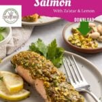 A plate of pistachio crusted salmon garnished with parsley and lemon slices, a fork resting nearby. In the background, a bowl of pistachios and a linen napkin add to the scene. Text reads Pistachio Crusted Salmon.