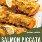 Baked salmon fillets topped with capers, sliced onions, fresh parsley, and lemon slices create a delicious salmon piccata dish. The label “Salmon Piccata with No Flour, No Wine” appears above on a green background.