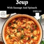 A large pot of creamy Tuscan Tortellini Soup with sausage and spinach, with an overlay reading Tuscan Tortellini Soup With Sausage And Spinach and a download button.